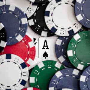 Close-up of poker chips with an ace of spades card, perfect for casino themes.